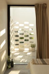 a bedroom with a sliding glass door to a patio at Casa Pavone in Carovigno