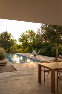 a swimming pool with two chairs and a table at Casa Pavone in Carovigno