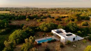 an aerial view of a white house with a swimming pool at Casa Pavone in Carovigno +18 photos