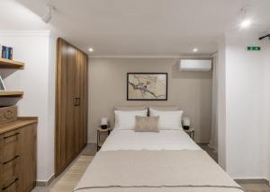 a bedroom with a large white bed and a wooden cabinet at Garden House Retreat-Suite in Drama