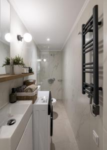 a white bathroom with a sink and a shower at Garden House Retreat-Suite in Drama +17 photos
