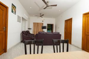 a living room with a couch and chairs at FM Villa Auroville in Pondicherry