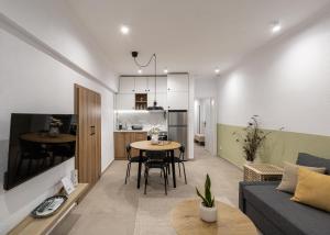 a living room and kitchen with a couch and a table at Garden House Retreat-Suite in Drama