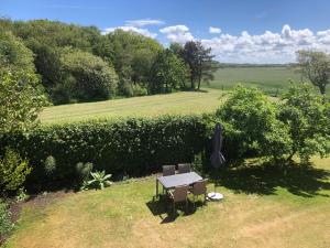 a picnic table and two chairs in a field at Ribe Dankirke Bed & Kitchen in Ribe