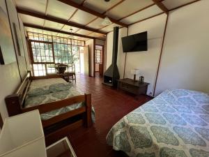 a bedroom with two beds and a flat screen tv at Mauruuru in La Pedrera