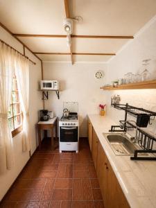 a kitchen with a stove and a sink at Mauruuru in La Pedrera +15 photos