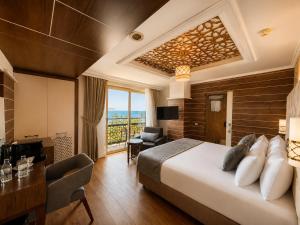 a hotel room with a large bed and a desk at Trend Park Hotel in Antalya