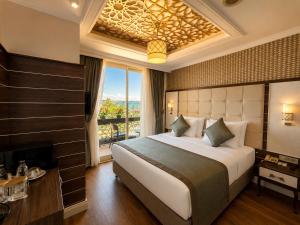 a bedroom with a large bed and a large window at Trend Park Hotel in Antalya +31 photos