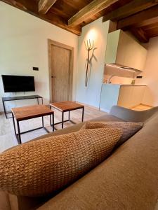 a living room with a couch and a table at Casa Corbeiras Apartamento 1 in A Pontenova