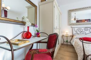 a room with a table and chairs and a bed at Guesthouse S&L in Dubrovnik