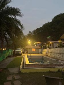 a parking lot with a car parked in a driveway at Valley King Resort in Mohan Chatti
