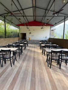 a large room with tables and chairs in it at Valley King Resort in Mohan Chatti