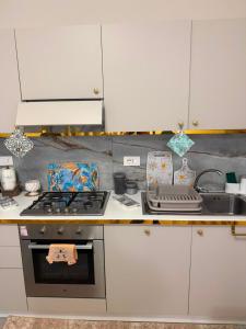 a kitchen counter with a stove and a sink at Sara B&B Accommodation in Santa Domenica