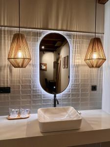 a bathroom with a sink and a mirror at Casa Corbeiras Apartamento 1 in A Pontenova