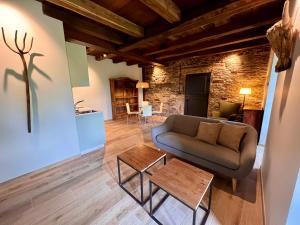 a living room with a couch and a table at Casa Corbeiras Apartamento 1 in A Pontenova +34 photos