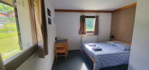 a small bedroom with a bed and a window at Le Shantoné in Saint-Michel-de-Maurienne