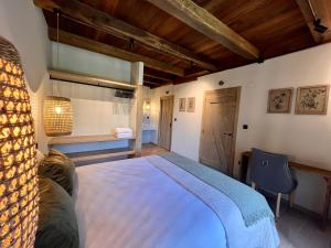 a bedroom with a large white bed in a room at Casa Corbeiras Apartamento 1 in A Pontenova