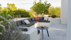 a patio with a couch and a table at Casa Pavone in Carovigno