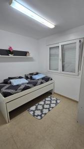 a bedroom with two beds and a window at Mediterraneo in Peniscola +16 photos