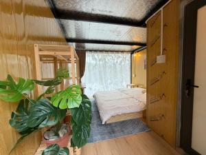 a bedroom with a bed and potted plants in it at Fish Farm Uncle Thanh in Xóm Soi (1) +53 photos
