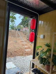 a sliding glass door with red lanterns on a house at Fish Farm Uncle Thanh in Xóm Soi (1)