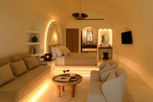 a living room with a couch and a bed at Avelora Suites in Pyrgos