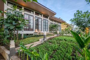 a house with a garden in front of it at Kadewa Retreat Ubud - Adults Only in Ubud