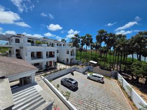 an aerial view of a white house with two cars parked at PSR Coral Resorts, 800m Away from Rameswaram Temple in Rāmeswaram