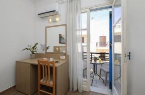 a bathroom with a vanity with a mirror and a table at Mare Naxia Hotel in Naxos Chora