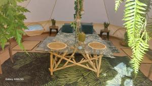a table and chairs in a room with plants at dame nature in Le Pener