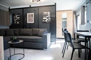 a living room with a couch and a table and chairs at Rooftop View Chios in Chios