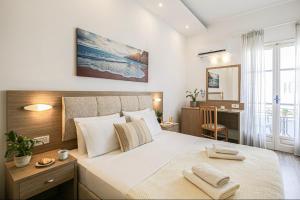 a bedroom with a large bed with towels on it at Mare Naxia Hotel in Naxos Chora +72 photos