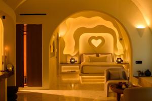 a bedroom with a bed in an archway at Avelora Suites in Pyrgos