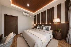 a bedroom with a large bed and a chair at Arterra Haven , Aonang Krabi in Ao Nang Beach