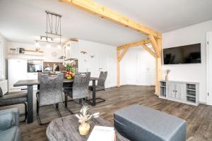 a living room and dining room with a table and chairs at Ferienhaus Alt-Gaarz in Lärz