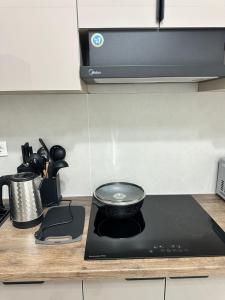 a stove top with a bowl on top of it in a kitchen at 7 Su Nury in Almaty