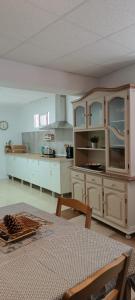 a kitchen with white cabinets and a table in it at Casa Ameghino in Laujar de Andarax