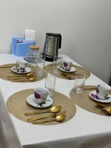 a table with plates and cups and silverware on it at 7 Su Nury in Almaty +6 photos