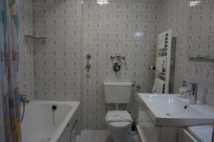 a bathroom with a toilet and a sink and a tub at Appartement Vogelnest in Oy-Mittelberg