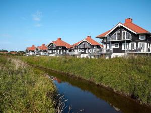 a row of houses next to a river at Bogense Ferieboliger 500 m til kysten in Bogense