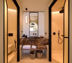 a bathroom with a sink and a mirror at Avelora Suites in Pyrgos