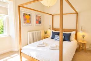 a bedroom with a bed with a wooden frame at Bakers Yard Cottage, Bonsall, Peak District in Bonsall