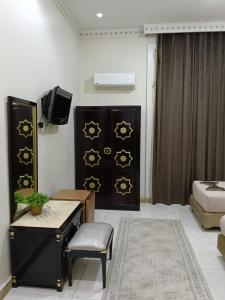 a room with a bed and a table and a tv at City View Museum Hotel in Cairo