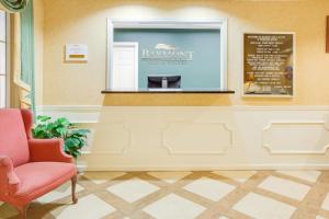 a waiting room with a chair and a menu at Baymont by Wyndham Ozark in Ozark +20 photos