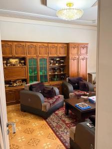 a living room with two couches and a table at holiday house in Gavarr