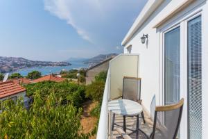 a balcony with a chair and a view of the water at Guesthouse S&L in Dubrovnik