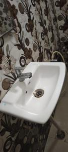 a white sink in a bathroom with a curtain at Hotel Ansh Palace - Village Near Taj Mahal Agra in Tājganj