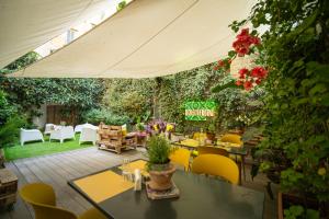 an outdoor patio with tables and chairs and flowers at Borgo Vergini Garden B&B in Naples +117 photos
