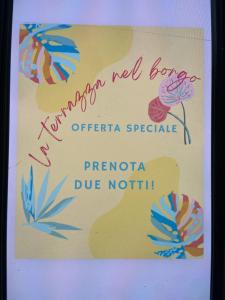 a sign for a new barber shop with flowers on it at La terrazza nel borgo in Tortora