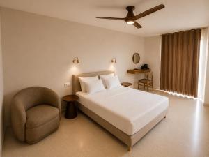 a bedroom with a bed and a chair at Regina Hotel in Kissamos +40 photos